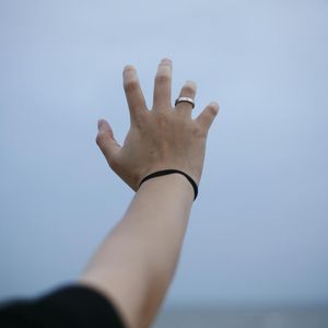 Close up of hands reaching for toes during stretch